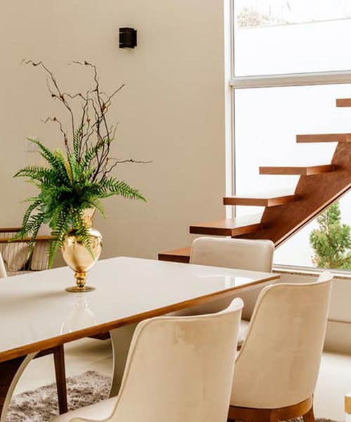 table and chairs by stairs in a house