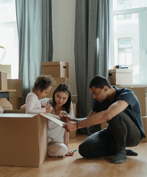 family surrounded by moving boxes